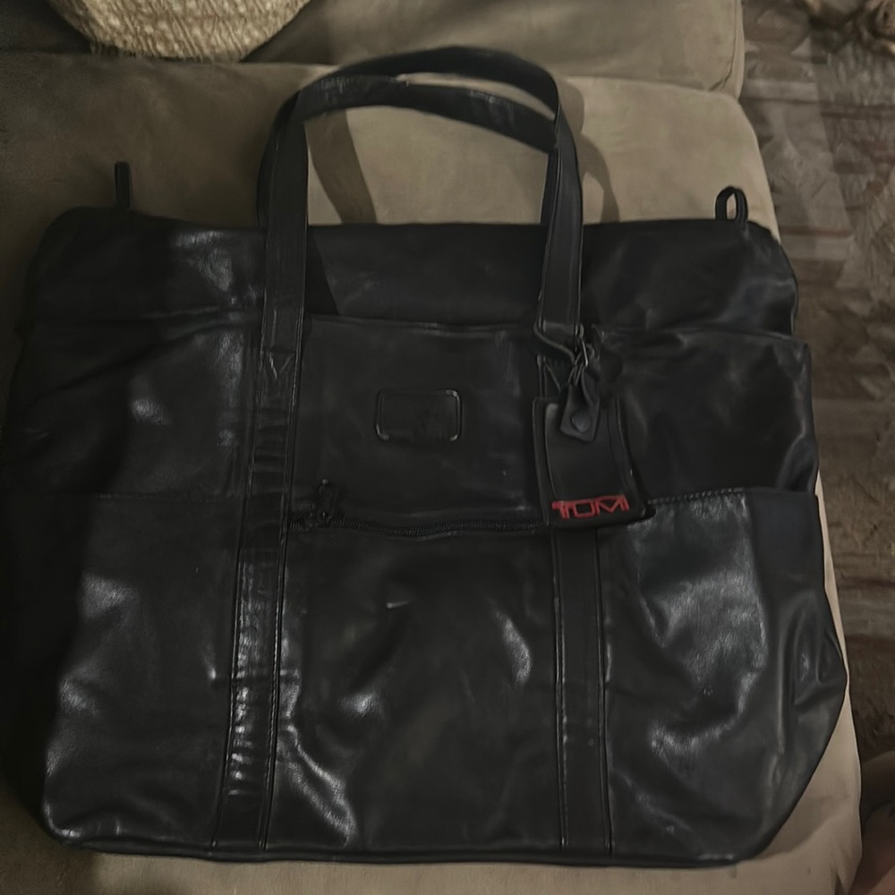 Tumi Black Travel Bag with Durable Design and Spacious Interior